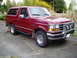 1993 Ford Bronco - This 1993 Ford Bronco is shown in a three-quarter front view, a chrome grille guard and a deep red paint job.