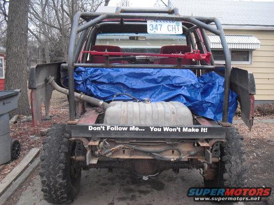 1986 Ford Bronco rear view with custom roll cage and large fuel tank visible