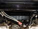 1995 Ford Bronco - The underside of a vehicle is shown, with focus on the frame, exhaust, and drivetrain components.