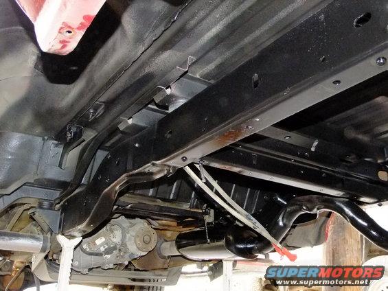 Underbody view of vehicle chassis, exhaust, and transfer case