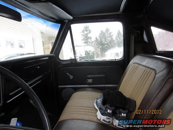 Interior of 1979 Ford Bronco with two-tone seats and a view of a snowy landscape