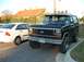 1985 Ford Bronco - A black Ford Bronco is parked next to a white sedan.