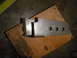 1995 Ford Bronco - Fabricated metal bracket with scribe lines and mounting holes.