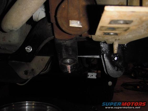 close-up of vehicle's suspension components and exhaust pipe