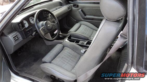 1989 Ford Mustang interior with grey cloth seats and dashboard