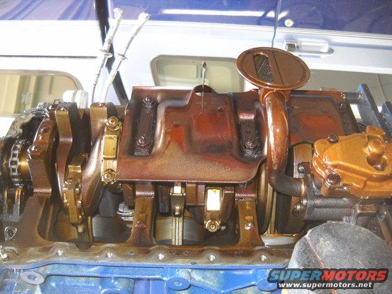 Close-up of an engine's oil pan and crankshaft assembly, showing internal components