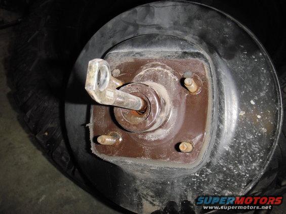 Close-up of a vehicle's brake drum assembly with a lug nut and studs visible