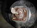1995 Ford Bronco - This image shows a close-up view of a vehicle's brake drum assembly, including the lug nut and studs.