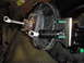 1995 Ford Bronco - Close-up of a brake booster and master cylinder assembly, showing mechanical components.