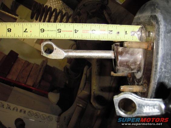 Brake booster pushrod measured with a yellow tape measure, showing approximately 3 inches extended