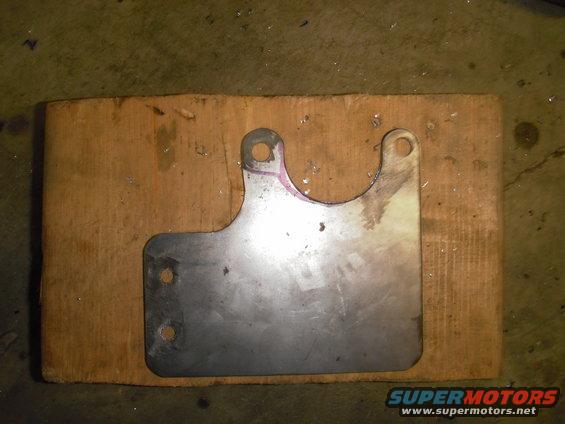 Metal bracket with two mounting holes on wood