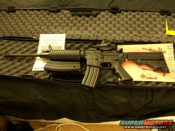 AR-15 rifle with manual and magazines in a case