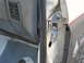 1991 Ford Bronco - This photo shows a close-up view of a vehicle's door hinge and an air vent on the interior panel.