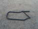 1991 Ford Bronco - A black metal door bar is shown lying on a gravel surface. The registry claims it is from a 1991 Ford Bronco, but this is unconfirmed.