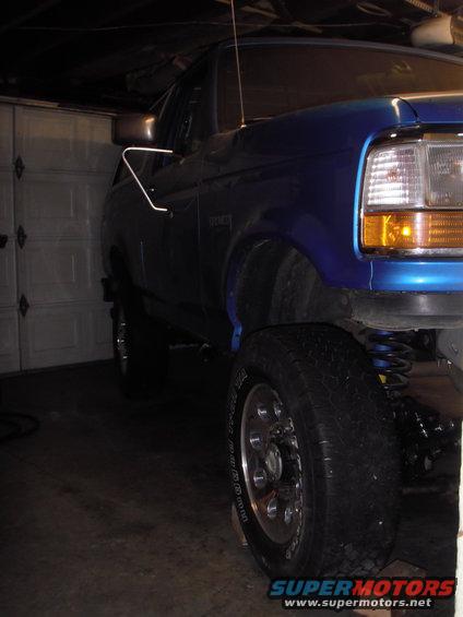 Blue 1995 Ford Bronco parked in a garage, front quarter view