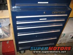 Blue Craftsman tool chest with multiple drawers. Some items are visible on a shelf to the left