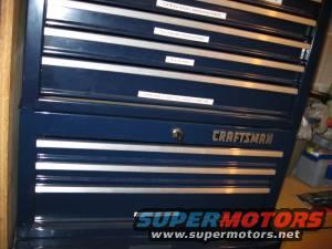 Dark blue Craftsman tool chest with silver drawer pulls and labels on drawers