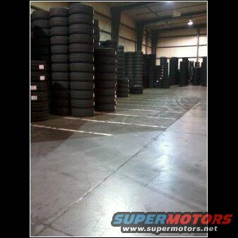 Warehouse full of stacked tires, some reaching the ceiling