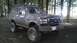 1995 Ford Bronco - This lifted Ford Bronco is covered in mud after an off-road excursion in a wooded area.