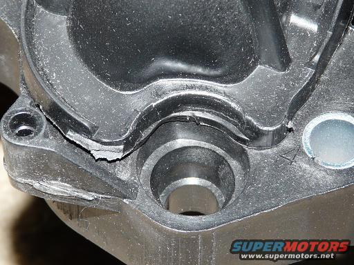 Cracked black plastic intake manifold part with metal insert
