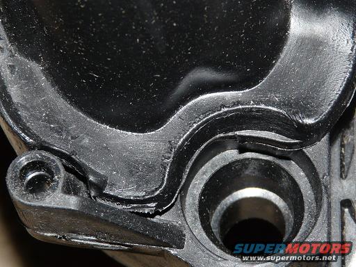 Black plastic intake manifold part with visible wear and a Supermotors.net logo