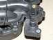 1999 Ford Crown Victoria - This is a close-up of a damaged plastic intake manifold part with hose connections.