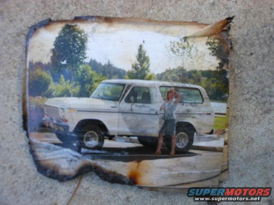 White Ford Bronco with a woman standing next to it