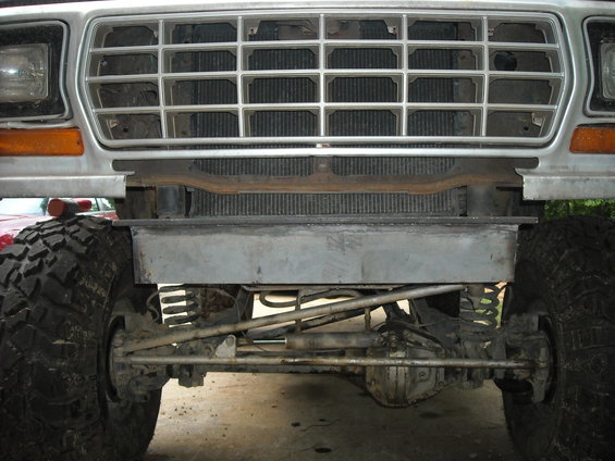 1979 Ford F-150 front end with large tires, aftermarket bumper, and grille