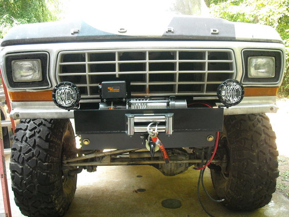 Front view of a 1979 Ford F-150 with a winch and KC lights mounted on the aftermarket bumper