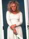1994 Jeep Cherokee - A woman stands with her arms crossed, holding a knife, looking down with a troubled expression.