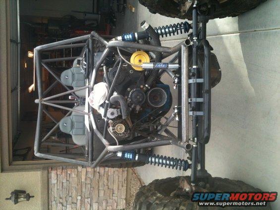 Off-road buggy chassis with exposed engine, dual seats, and suspension components