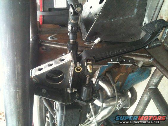 Close-up of steering column, pedals, and engine components in a custom buggy