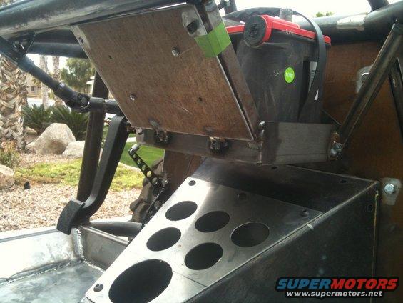 Buggy interior with battery, pedals, and custom metalwork. A Supermotors.net watermark is visible