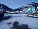 2009 Kenworth T800 - Multiple vehicles, including trucks and SUVs, are parked in a snowy lot with mountains visible.