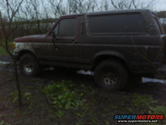 Mud-covered 1989 Ford Bronco parked in a muddy field