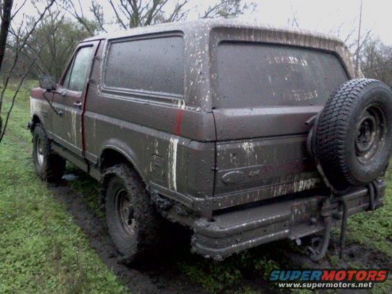 Mud-covered 1989 Ford Bronco rear view with spare tire