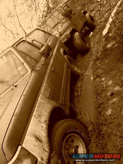 1989 Ford Bronco stuck in mud, side view