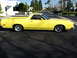 1979 Ford Ranchero - A yellow 1979 Ford Ranchero is parked in a lot, viewed from the side.