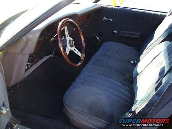 1979 Ford Ranchero interior with blue velour bench seat and wood-rimmed steering wheel