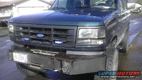 1995 Ford Bronco front end with custom bumper and blue lights in grille