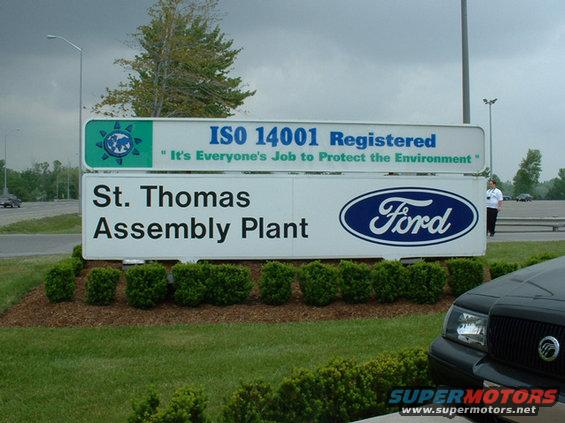 Sign for Ford St. Thomas Assembly Plant, ISO 14001 Registered. Part of a black car in foreground