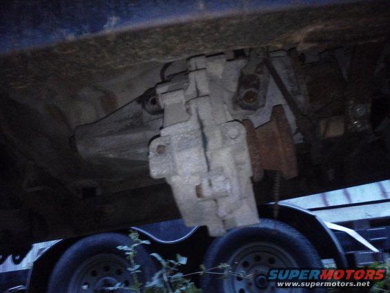 Underside view of a vehicle's transfer case, mounted on a trailer