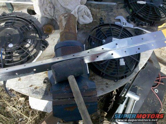 two electric fans, a vise, hammer, and metal bracket