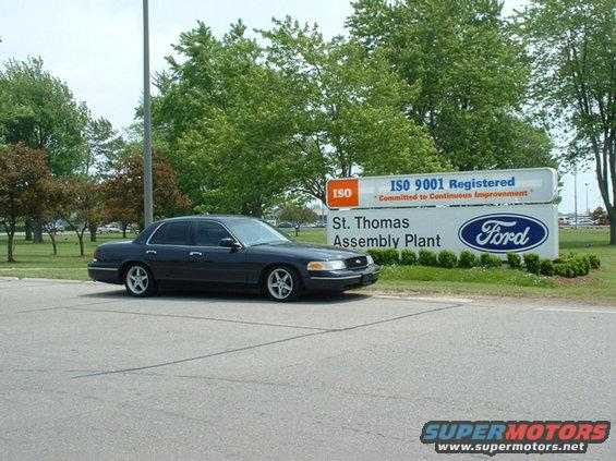 Dark blue 2000 Ford Crown Victoria parked near a sign for St. Thomas Assembly Plant