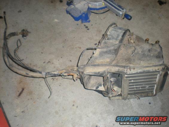 HVAC unit with hoses and wires on concrete floor