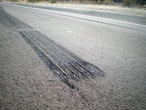 Tire marks on a paved road, showing evidence of braking or acceleration