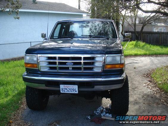 Front view of a dark blue 1994 Ford F-250 pickup truck parked in a driveway
