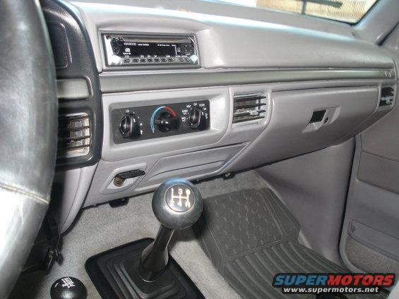 Interior view of truck with manual shifter and Kenwood radio