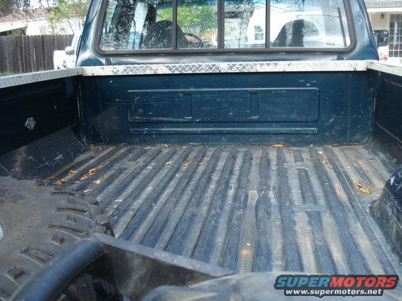 Dark blue 1994 Ford F-250 pickup truck bed with diamond plate trim