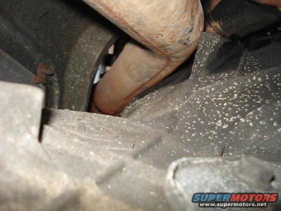 Close-up of exhaust pipe and transmission housing underside
